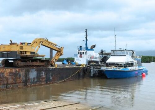 Work barge and workboats at North Wharf in Cairns Port - the Marine facility of company North Marine